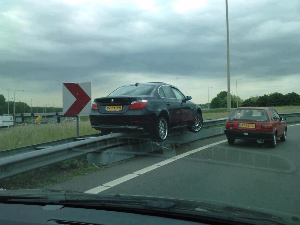 car on guardrail